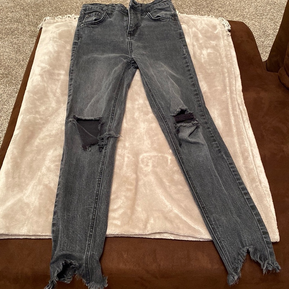 Black distressed jeans.